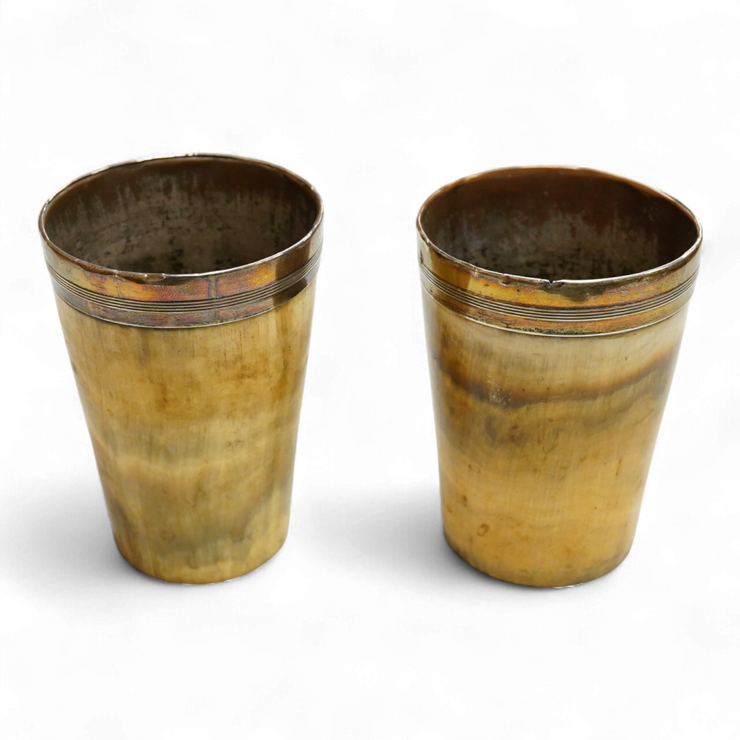 A near pair of 19th century white metal mounted horn beakers, unmarked, height 10.2cm et infra.